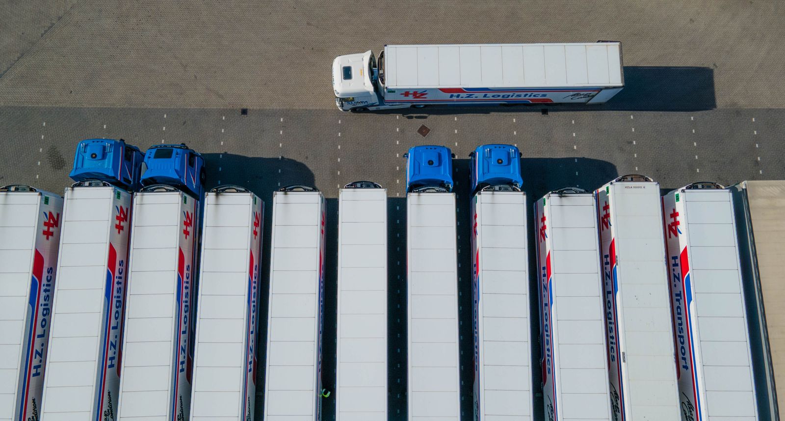 Aerial view of logistics trucks in a fleet yard representing fleet intelligence and GPS analytics